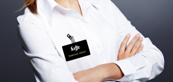 Portrait of a beautiful young business woman standing against gr